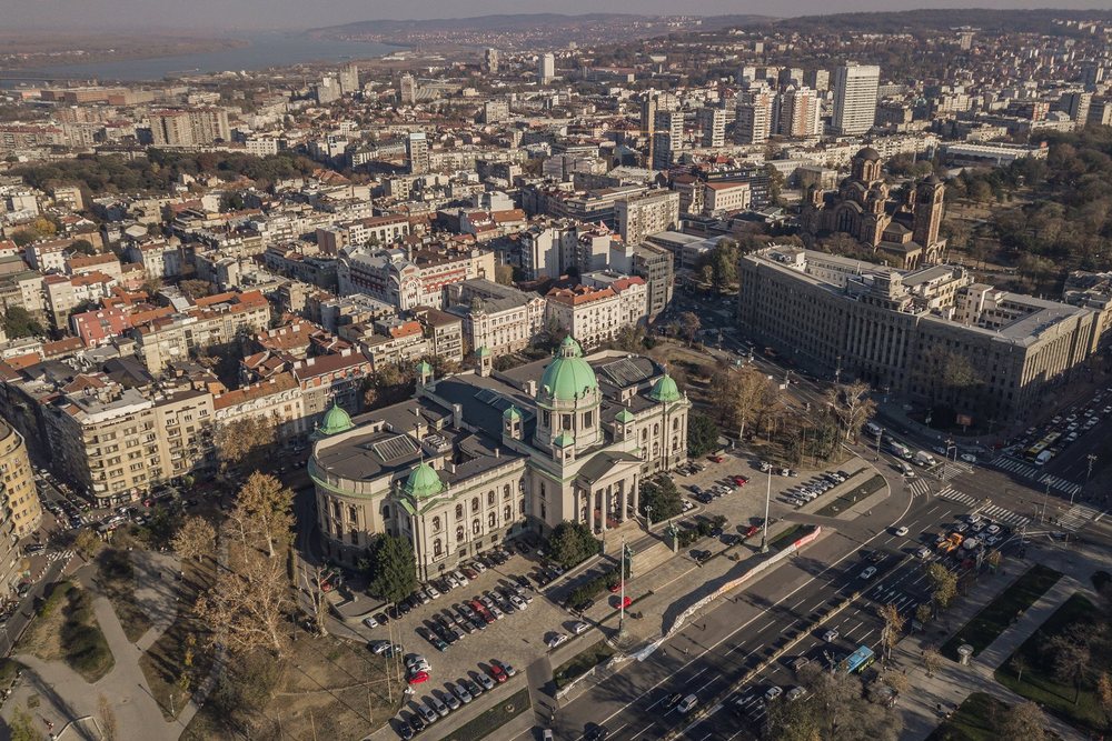 A parliament building and the city around it, from the air